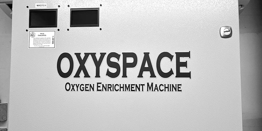The front panel of an OxySpace oxygen enrichment machine: two display windows, a field evaluation label and the OxySpace wordmark.