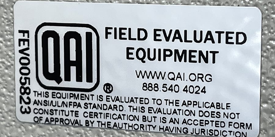 A QAI "Field Evaluated Equipment" label, number FEV005823, stating the evaluation does not constitute certification.